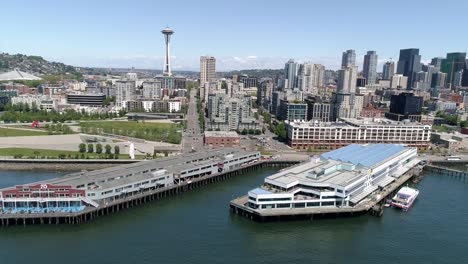 Luftaufnahmen-von-Seattle,-Washington-touristische-Attraktion-der-Waterfront-Piers-mit-Welt-berühmtes-Wahrzeichen-in-der-Skyline-der-Stadt