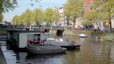 A-small-gray-boat-docking-on-the-side-of-the-floating-house