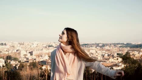 Portrait-of-young-beautiful-woman-waiting-somebody-against-the-panorama-of-Roma,-Italy.-Attractive-female-enjoy-the-day