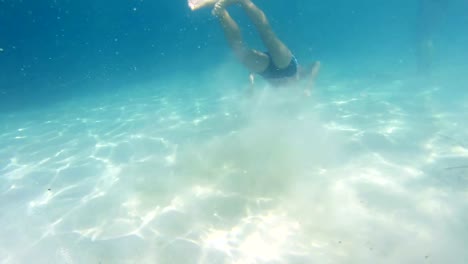 handsome-boy-having-fun-diving-in-clean-caribian-waters-off-the-camera