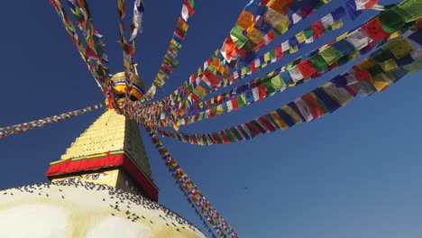 Buddhist-prayer-flags-(Dar-Cho)-on-Boudhanath-stupa-in-Kathmandu,-Nepal.-Slow-motion-shot