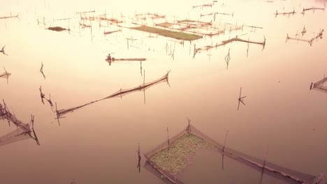 Fishermen-preparing-his-fishing-nets-at-sunrise-for-catching-fish-at-Rowo-Apung-Floating-Place-Jombor-Klaten,-Yogyakarta-Indonesia