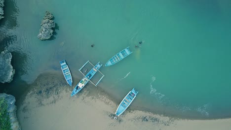 Baron-beach-traditional-fishing-boats-docked-to-the-shore-aerial-view,-Yogyakarta,-Indonesia