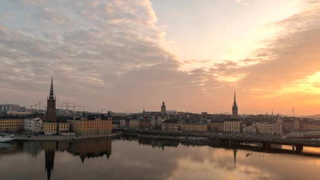 Stockholm-city-skyline-night-to-day-sunrise-timelapse-at-Gamla-Stan-and-Slussen,-Stockholm-Sweden-4K-Time-Lapse