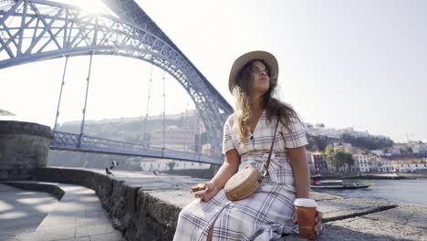 Young-girl-have-a-bit-on-embankmet-in-sunny-day