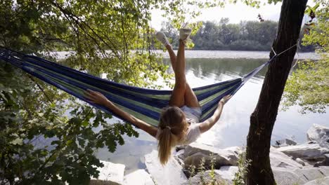 Entspannen-Sie-sich-auf-Hängematte-am-Fluss,-junge-Frau-Hände-hinter-Kopf-ruhigen-grüne-Umgebung-genießen.-Menschen-reisen-Konzept-im-Urlaub-entspannen