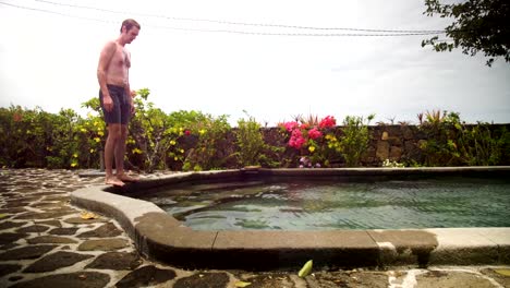 man-walking-in-pool-and-swim