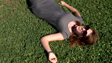 Young-beautiful-woman-laying-in-clover.