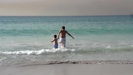 2-young-boys-running-into-the-sea,-Cape-Town,South-Africa