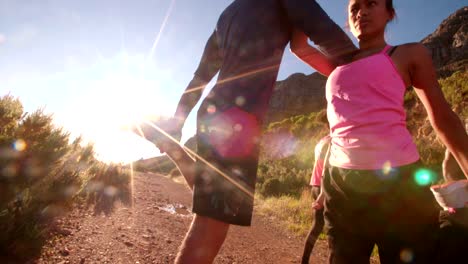 Young-couple-warming-up-before-running-outdoors