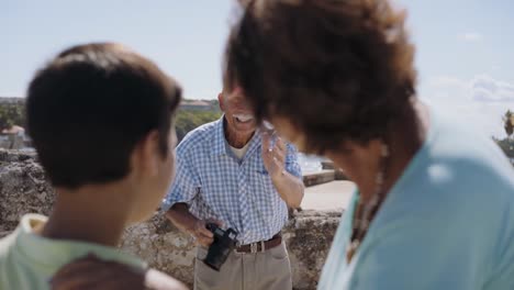 Family-On-Holidays-In-Cuba-Grandpa-Tourist-Taking-Photo