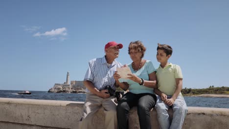 Family-Grandparents-Reading-Tourist-Map-In-Habana-Cuba