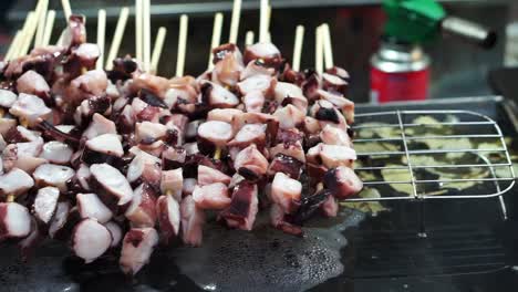 Local-street-food-of-Seoul,-Korea,-Octopus-skewer-steam-and-burn-cooked-before-eating