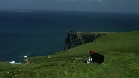 4-k-Schuss-eine-rothaarige-Dame-auf-den-Klippen-von-Moher-anzeigen-in-Irland