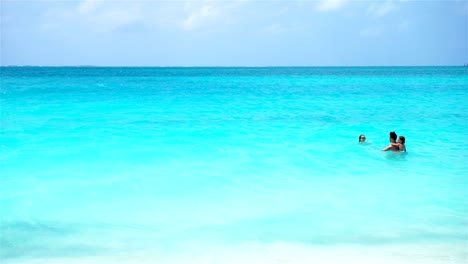 Father-and-kids-swimming-in-the-sea