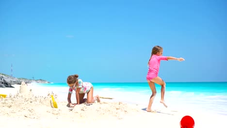 Happy-little-kids-playing-with-beach-toys-during-tropical-vacation
