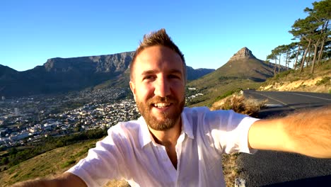 Young-man-taking-selfie-portrait-in-Cape-Town-at-sunrise