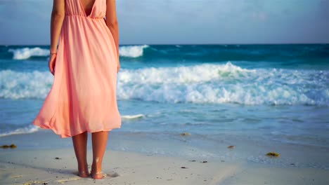 Beautiful-woman-on-white-beach.-Closeup-female-legs.-SLOW-MOTION