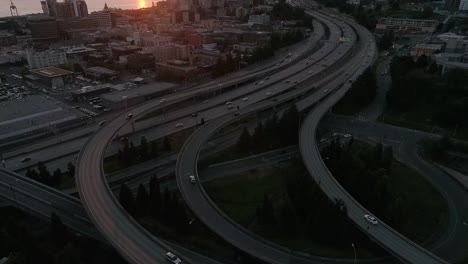 Sunset-Aerial-of-Interstate-5-in-Seattle,-Washington-with-Puget-Sound-and-Olympic-Mountain-Range