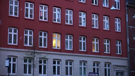 Beautiful-architecture-classic-European-style-apartment-building.-One-room-lit-with-light-abstract