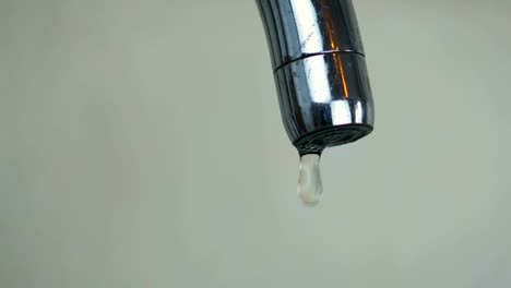 Close-up-abstract-a-droplets-of-water-drip-from-the-tap-in-the-kitchen-at-home.