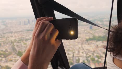 Helicopter-Passenger-Filming-With-Phone