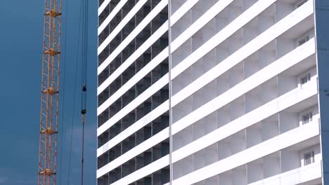 Construction-of-a-multi-storey-building.-House-and-construction-crane-on-sky-background.