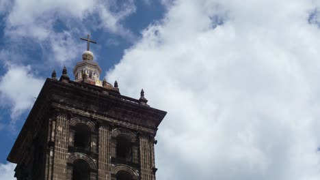 Time-lapse-of-clouds-streaming-by-the-tower-of-an-ancient-Mexican-Cathedral