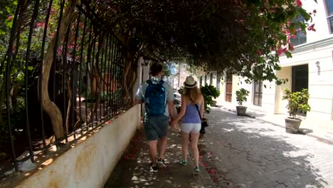 Tourist-couple-walking-down-street-in-Old-Havana-Cuba