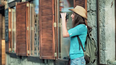 Backpacker-woman-taking-picture-of-amazing-architecture-and-cityscape-near-European-style-window