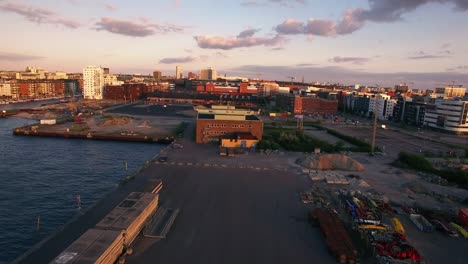 Aerial-view-of-industrial-area-by-the-water-in-Malmo,-Sweden.-Apartment-buildings-and-harbor