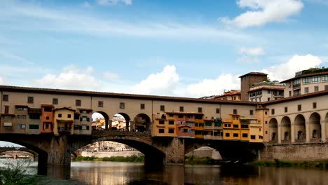 Florence-in-Italy.-Ponte-Vecchio-on-a-sunny-day.-The-famous-medieval-bridge-over-the-Arno-river,-in-Florence,-Italy.-Timelapse-and-zoom-effect,-4K-UHD-Video.-Nikon-D300