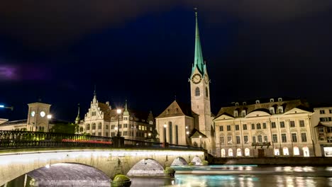 Zurich-Switzerland-time-lapse-4K,-city-skyline-night-timelapse-at-Fraumunster-Church-and-Munster-Bridge