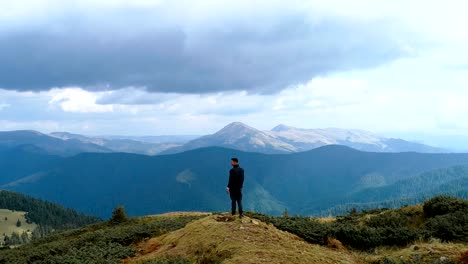 The-man-standing-on-the-top-of-the-mountain-with-a-beautiful-view