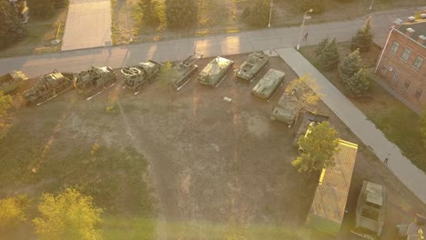 aerial-view-of-row-of-military-vehicles-machines-during-sunset