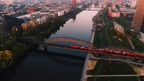 Frankfurt-Aerial-River-Shot-at-early-sunrise-train-over-bridge