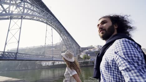 Couple-in-sun-shine-walking-on-embankment