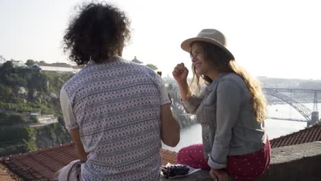 Couple-picnic-on-the-street-of-Porto-over-roofs