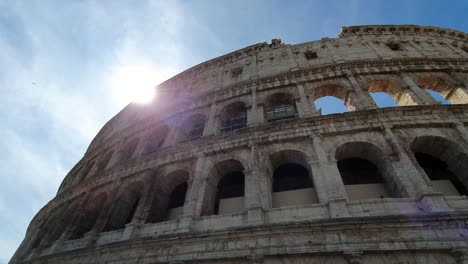 A-ray-of-sun-passes-through-the-arches-of-the-Colosseum-in-Rome,-Italy.