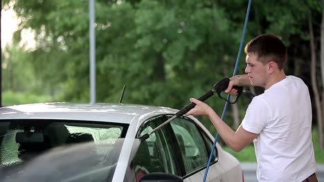 man-in-a-white-t-shirt-white-car-washes.-Slow-motion