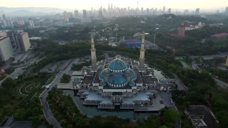 Aerial-view-of-sunrise-at-Federal-Mosque-Kuala-Lumpur-with-city-skyline-at-the-background