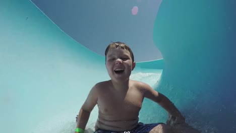 Happy-young-boy-going-down-waterslide-Cape-Town