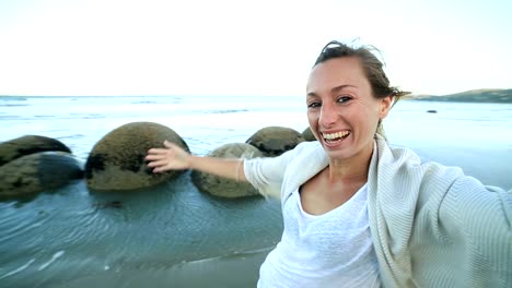 Self-portrait-of-young-woman-at-the-Moeraki-boulders-New-Zealand