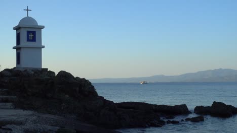 A-small-Greek-chapel-with-cross-near-Aegean-sea-in-Kassandra-peninsula-in-Greece