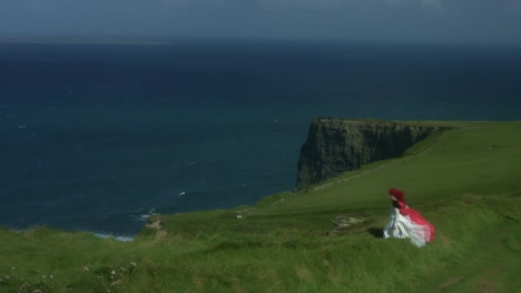 4k-Shot-of-a-Redhead-princess-on-Cliffs-of-Moher-View-in-Ireland