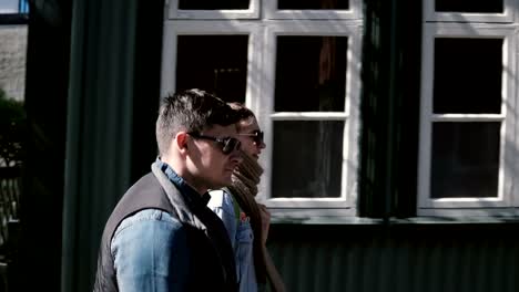 Young-beautiful-man-and-woman-walking-in-sunny-urban-city.-Stylish-couple-on-a-romantic-date-together