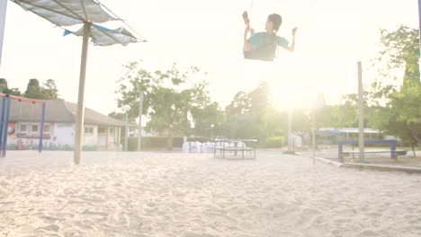 Children-swinging-together-at-a-public-playground