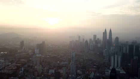 Cielo-ardiente-contra-rascacielos-de-Kuala-Lumpur-con-niebla-y-niebla-por-la-mañana.