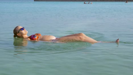 Pregnant-woman-and-her-son-bathing-in-Dead-Sea-and-having-fun
