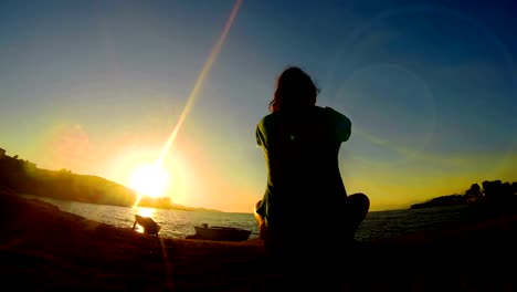 Meditación-de-verano-cerca-del-mar-y-haciendo-yoga-en-una-playa-al-amanecer-con-cielo-colorido-increíble